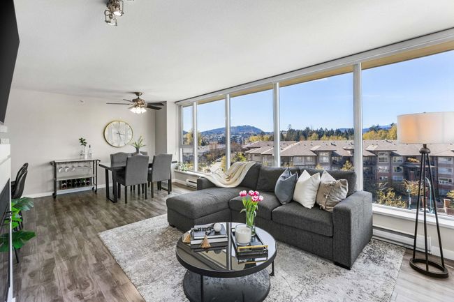 Living area featuring baseboards, wood finished floors, ceiling fan, and a mountain view | Image 5