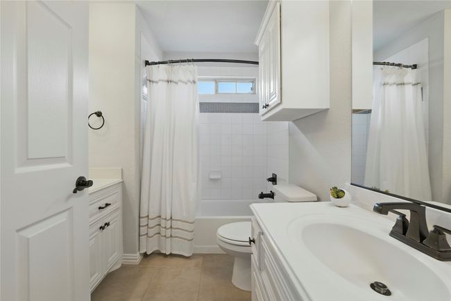 Bathroom featuring vanity, tile patterned floors, and shower / bath combination with curtain | Image 32