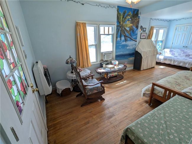 Bedroom featuring cooling unit, heating unit, and hardwood / wood-style flooring | Image 12