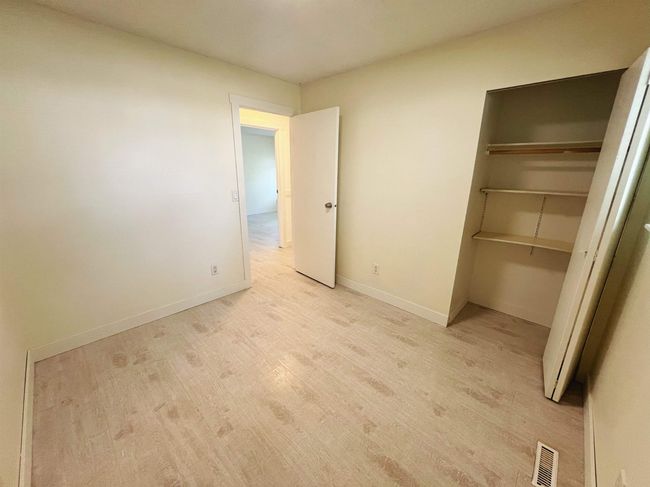 Unfurnished bedroom with light wood finished floors and a closet | Image 10