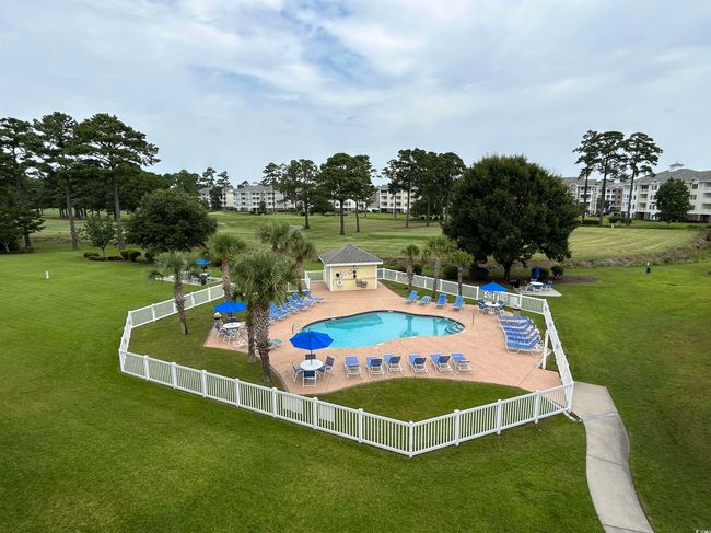 Community pool with a patio, a yard, and fence | Image 36