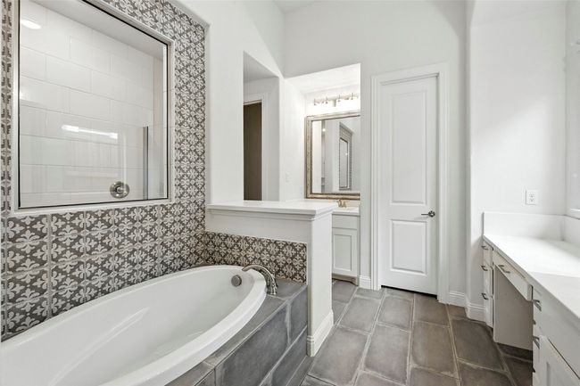 Bathroom with vanity, a bath, and tile patterned flooring | Image 21