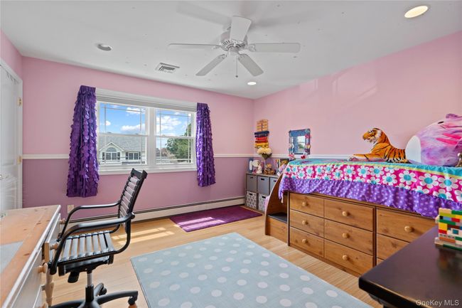 Bedroom with light wood-type flooring, recessed lighting, a ceiling fan, and baseboard heating | Image 13
