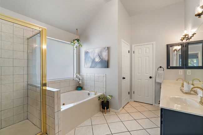 Full bath with a sink, a garden tub, tile patterned flooring, and a shower stall | Image 25