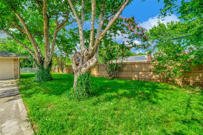 View of yard with a garage and concrete driveway | Image 29
