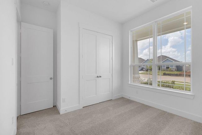 Located downstairs, this secondary bedroom is ideal for a growing family or a visiting parent, with a full bathroom located just outside the bedroom door in the hallway. | Image 16