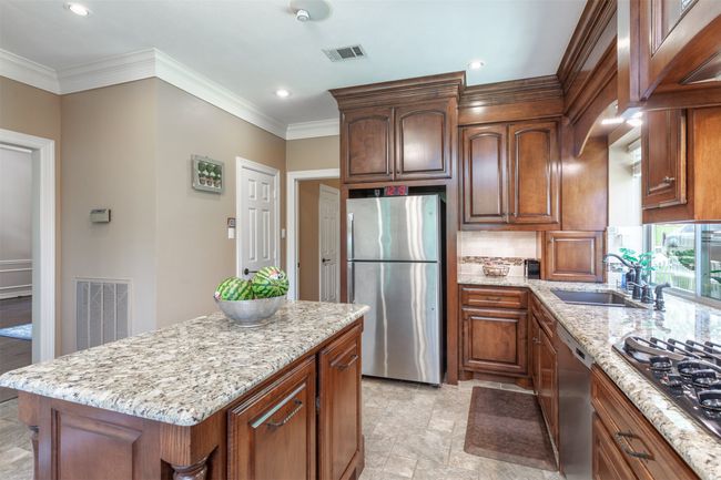 Kitchen featuring appliances with stainless steel finishes and gas cook top | Image 14