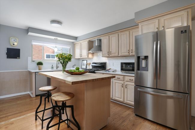 Spacious kitchen with butcher block center island | Image 5