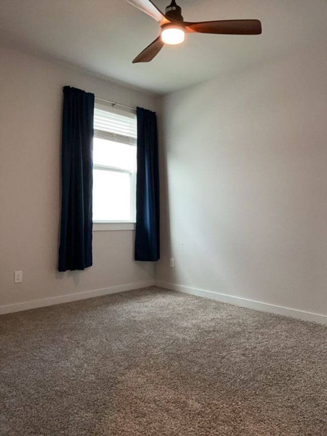 Bed room featuring a ceiling fan and carpet flooring | Image 29