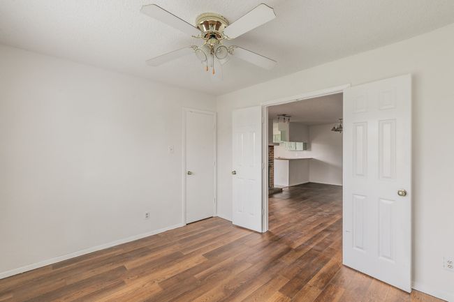 Spare room with wood finished floors, a ceiling fan, and baseboards | Image 22