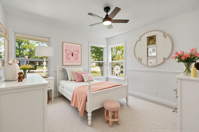 Bedroom featuring light colored carpet and ceiling fan | Image 15