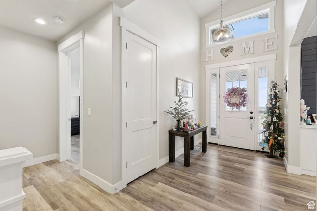 Foyer entrance featuring a high ceiling, light wood finished floors, recessed lighting, and baseboards | Image 10