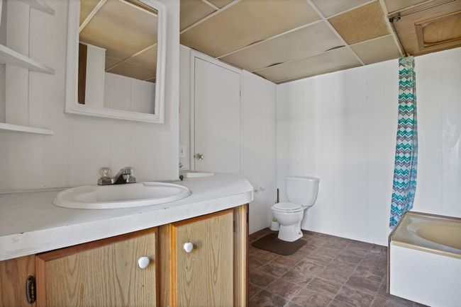 Bathroom featuring vanity, toilet, and shower / bathtub combination with curtain | Image 15