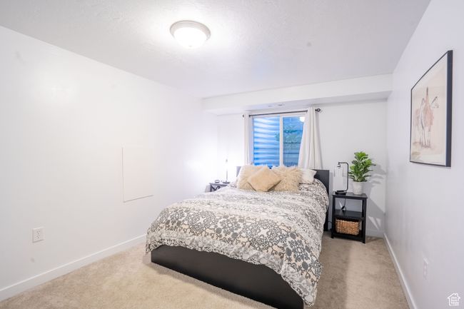 Bedroom featuring light colored carpet | Image 31