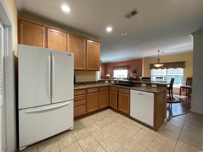 Kitchen Updated, One Bowl Sink, White Appliances, a Breakfast Bar & Tiled Flooring. | Image 11