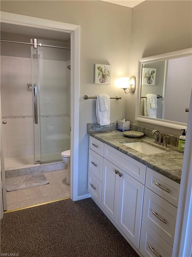 Bathroom with vanity, a stall shower, and tile patterned floors | Image 14