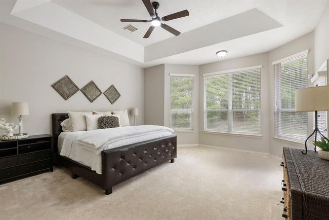 Spacious primary suite offers sitting area with views and access door to pool and spa. | Image 20