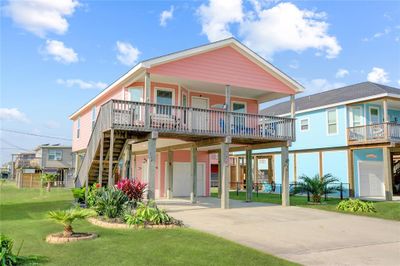 EMBRACE COASTAL LIVING IN THIS BRIGHT AND AIRY BEACH HOUSE, SURROUNDED BY LUSH GREENERY AND OFFERING AN INVITING STAIRCASE THAT LEADS YOU UP TO YOUR PARADISE. | Image 2