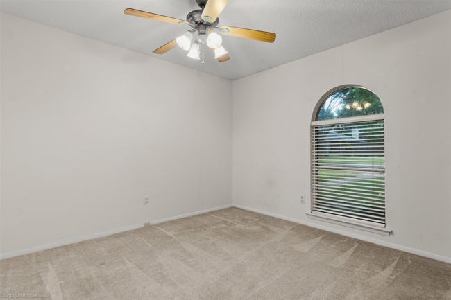 Unfurnished room featuring carpet floors, ceiling fan, and baseboards | Image 14