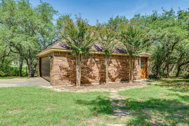 This detached 2 car garage provides a wonderful flex space for cars, a shop, or a place to do your yoga! | Image 31