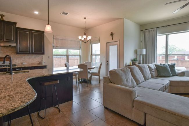 Living room featuring tile patterned floors, visible vents, recessed lighting, and a healthy amount of sunlight | Image 7