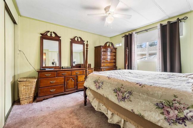 Bedroom with light carpet and ceiling fan | Image 19