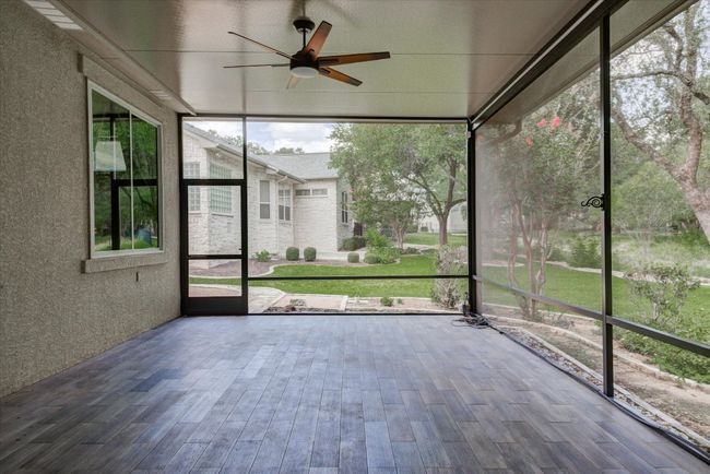 Sunroom with ceiling fan and beautiful floors | Image 34