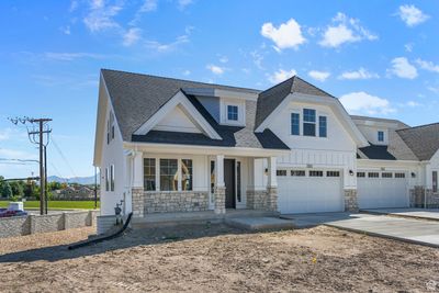 View of front of home with a porch and a garage | Image 2