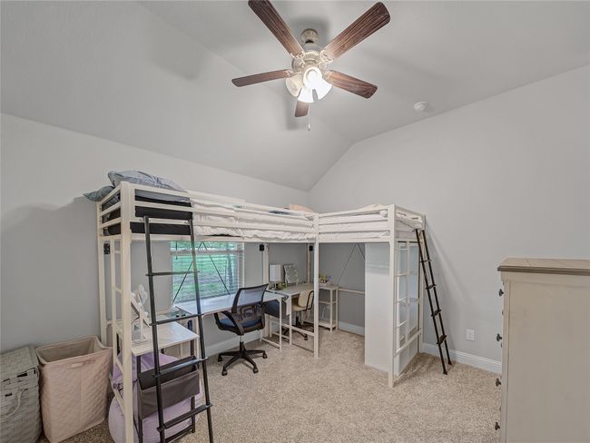 Bedroom featuring a desk, carpet floors, vaulted ceiling, and a ceiling fan | Image 26