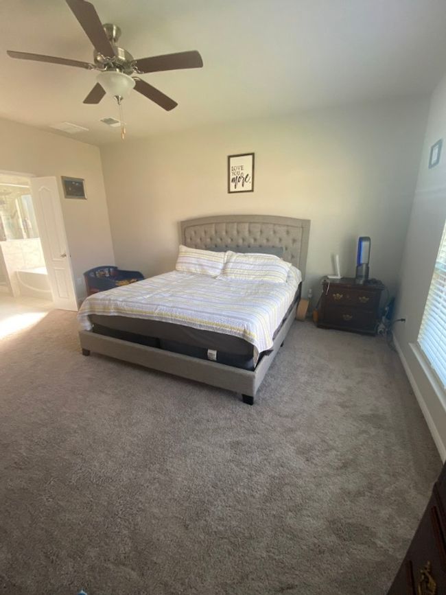 Bedroom with carpet flooring, a ceiling fan, and visible vents | Image 17