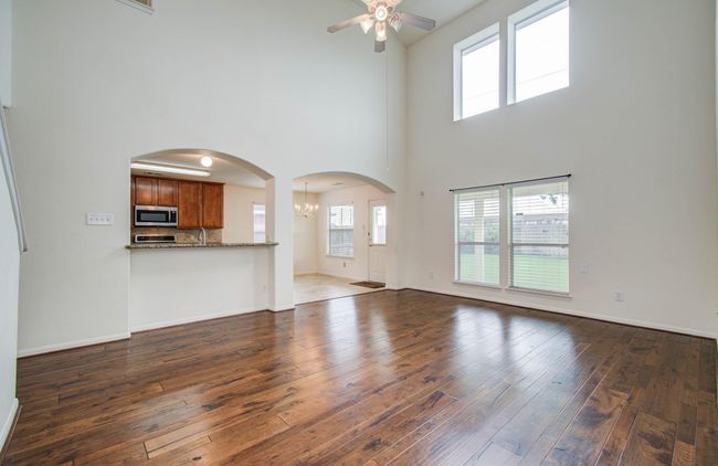 The dramatic 2-story wall of windows provides great natural light and a beautiful backdrop for your furnishings. The windows have 3" faux wood blinds. | Image 17