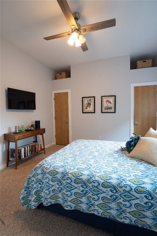Carpeted bedroom with a ceiling fan | Image 11