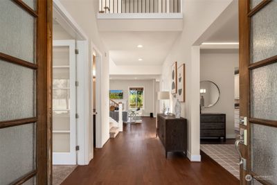 Step inside to a grand foyer with a soaring ceiling and stunning hardwood floors. | Image 2