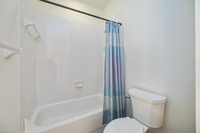 Bathroom featuring shower / bath combo with shower curtain and toilet | Image 19