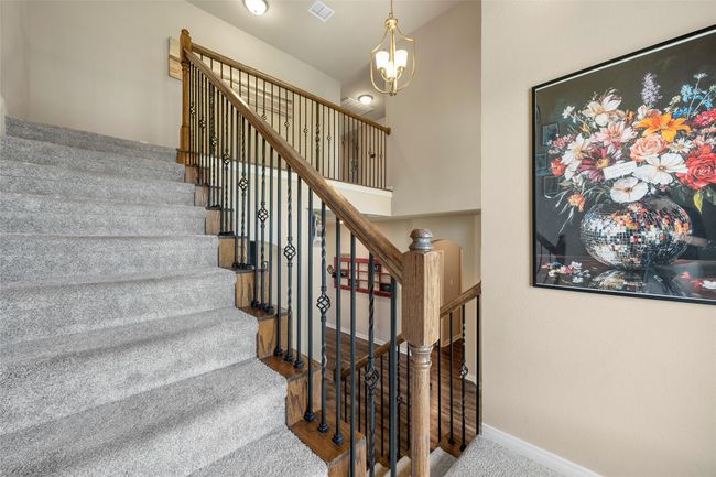 Stairs with a chandelier and carpet flooring | Image 22