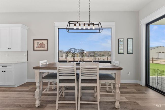 Dining room with wood finished floors and a chandelier | Image 16