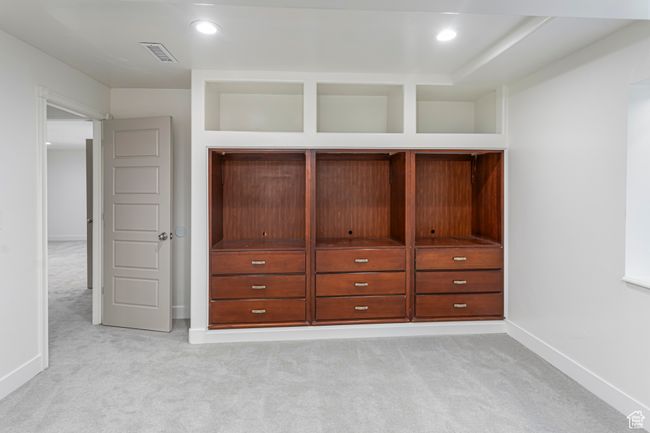 Interior space featuring baseboards, visible vents, light carpet, and recessed lighting | Image 28