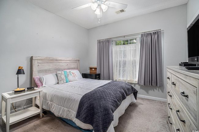 Bedroom with carpet flooring and a ceiling fan | Image 12