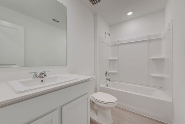 Bathroom with bathtub / shower combination, light wood-type flooring, and vanity | Image 17