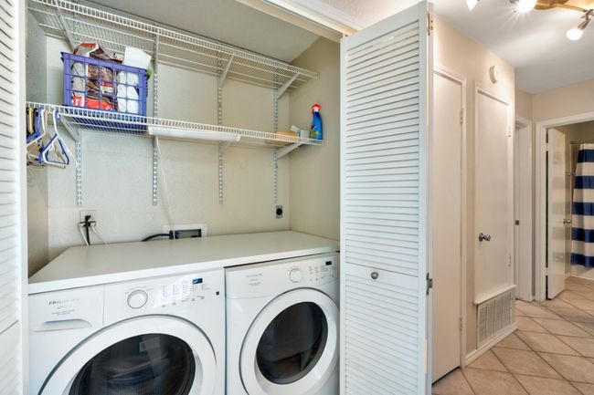 Laundry closet is located in the hallway for easy access and features shelving for additional storage. | Image 22