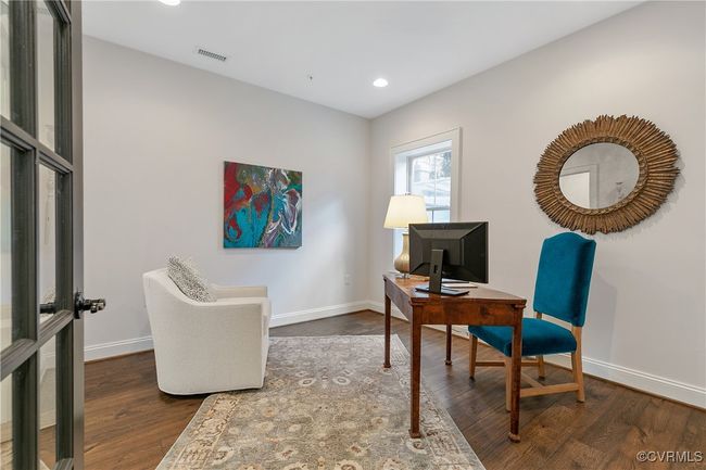 Home office featuring dark wood-style floors, baseboards, visible vents, and recessed lighting | Image 37
