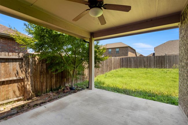 Fenced backyard featuring ceiling fan and a patio | Image 33