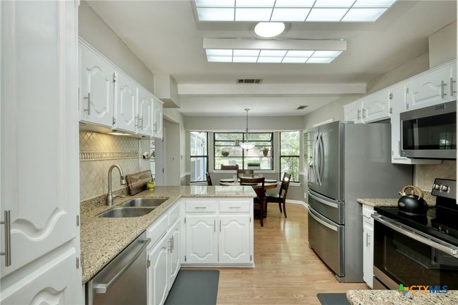 Kitchen with granite counters and stainless appliances | Image 8