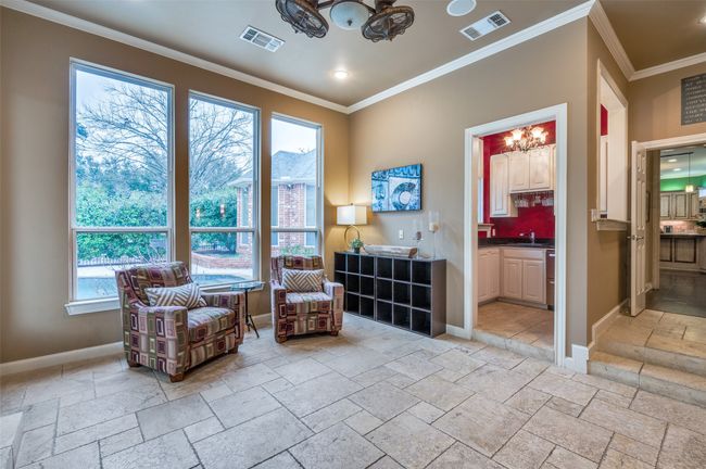 Sitting room with stone tile floors, a chandelier, baseboards, ornamental molding, and recessed lighting | Image 11