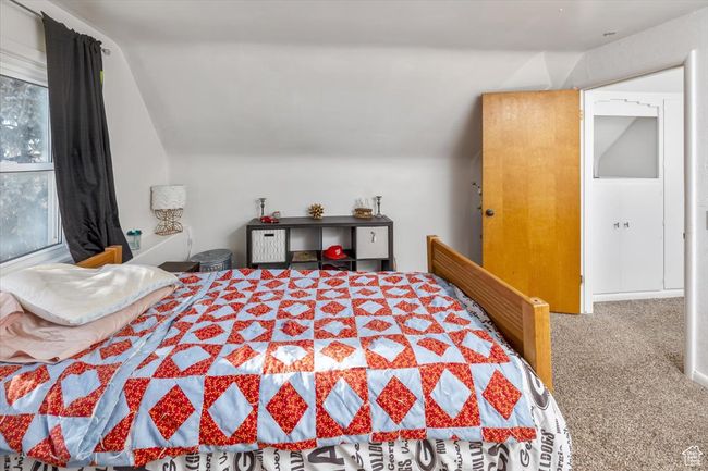 Bedroom featuring vaulted ceiling, carpet flooring, and multiple windows | Image 28
