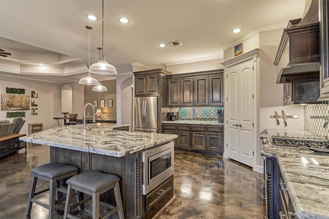 The microwave is thoughtfully tucked away in the center island, maintaining the clean lines of the kitchen while adding convenience and functionality. | Image 23