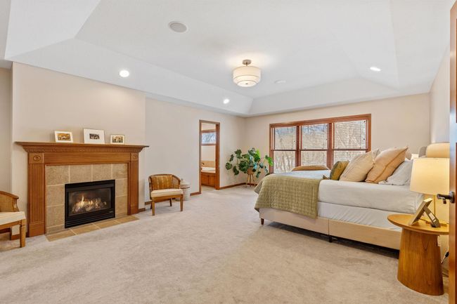 Massive primary suite with fireplace, large walk-in closet and ensuite with heated flooring. | Image 27