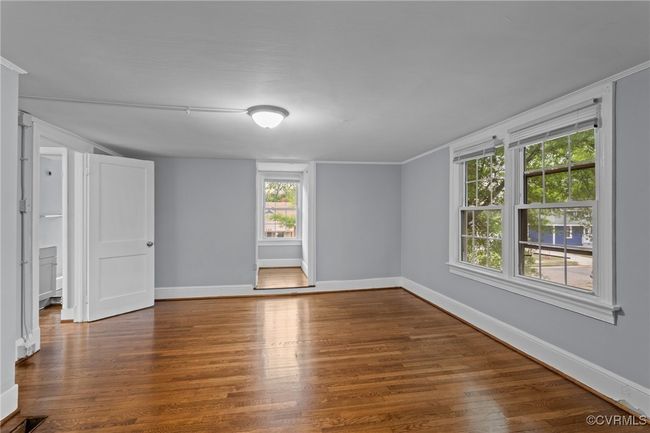Unfurnished room with plenty of natural light, wood finished floors, and baseboards | Image 23