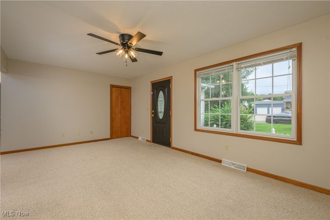 Spare room featuring carpet flooring and a ceiling fan | Image 8