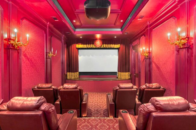 Carpeted home theater featuring crown molding | Image 26